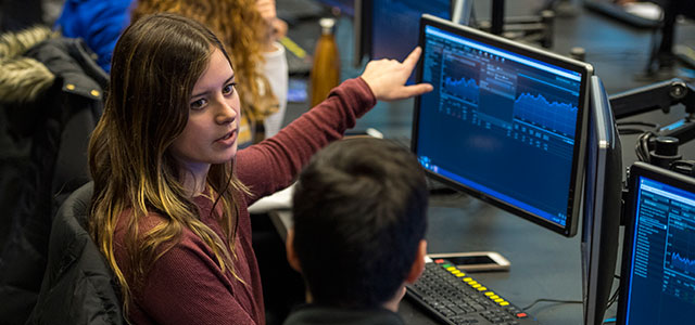 Student working in the Geltzeiler Trading Center; a part of the Lerner College of Business and Education