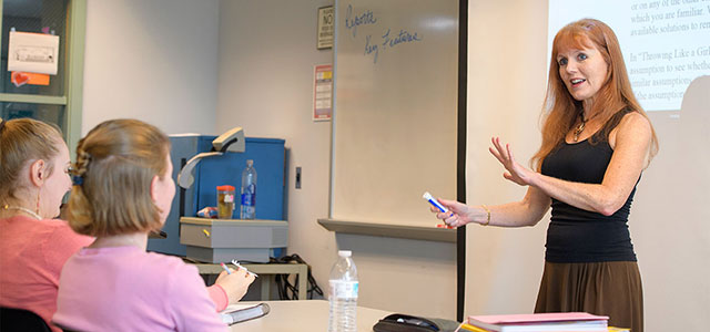 A Professor in the Associate in Arts Program lectures to engaged students