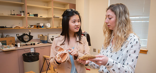 Students in the College of Arts and Sciences discuss a project.