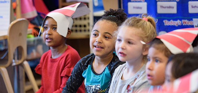 Children learning from a College of Education and Human Development student. 